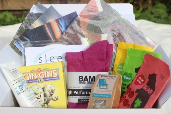 Healing box with lots of gifts bursting out, nicluding ginger sweets, tea, socks and more