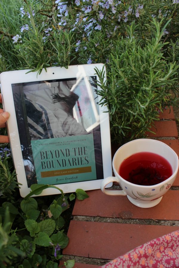 Tablet displaying ebook by a wall with a cup of tea